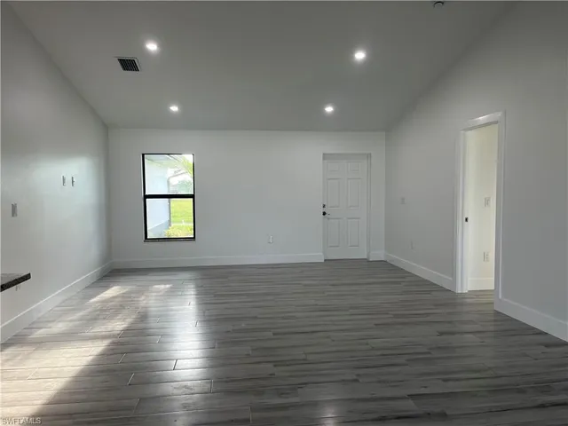 a view of kitchen with wooden floor and electronic appliances