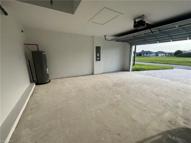 a kitchen with stainless steel appliances granite countertop a white cabinets a sink a stove a refrigerator and island