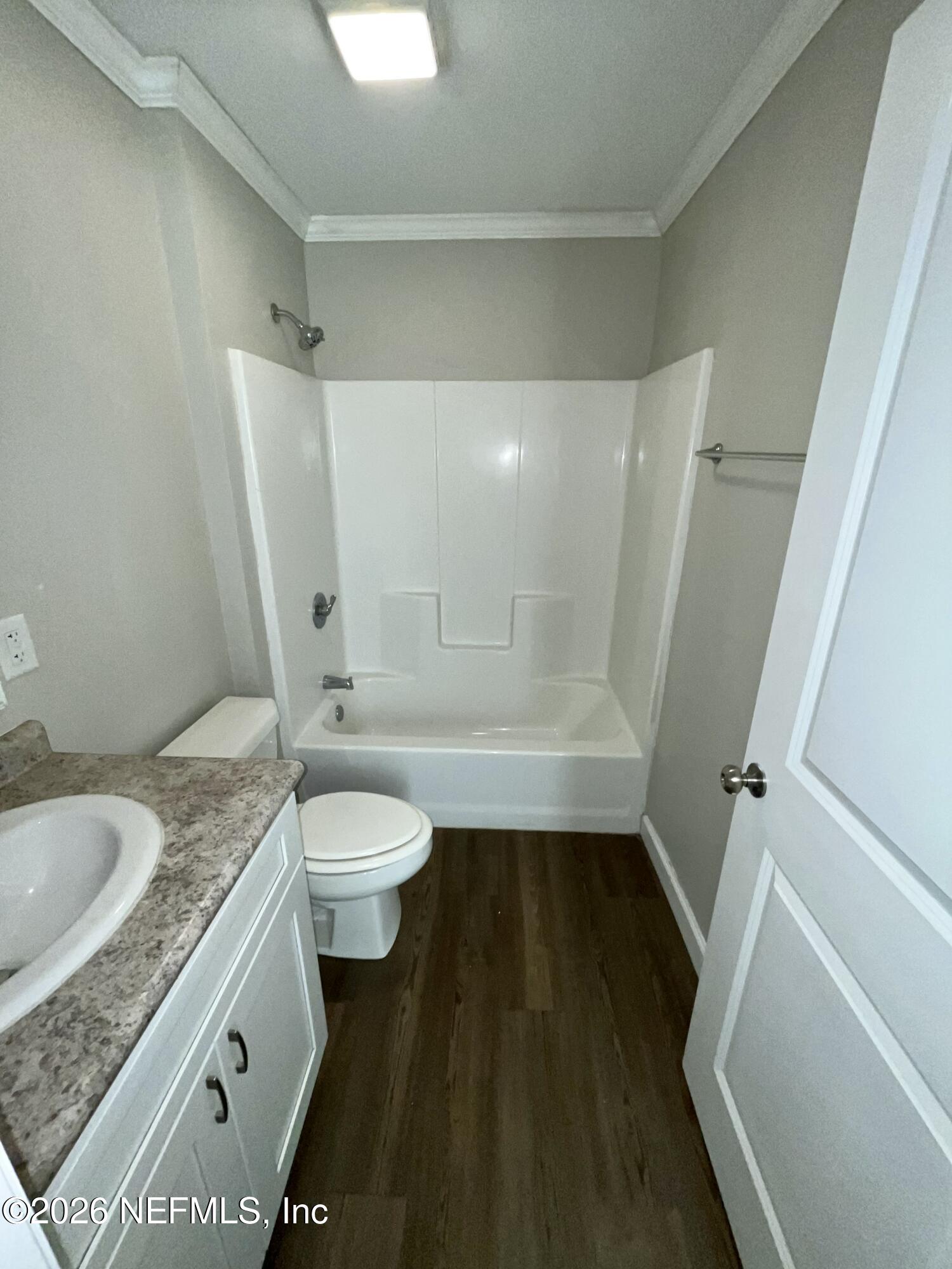 2017 Talladega Road Jacksonville, FL 32209 - Photo 33 of 34 a bathroom with a granite countertop sink toilet and shower