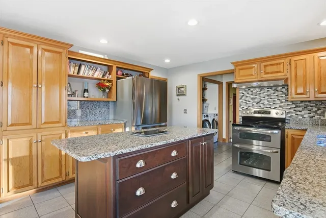 a kitchen with a stove a sink and a refrigerator
