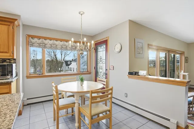 a dining room with furniture a chandelier and wooden floor