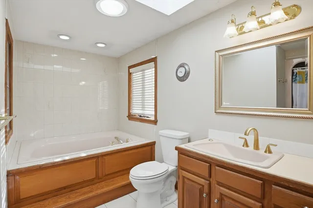 a bathroom with a sink a toilet and bathtub