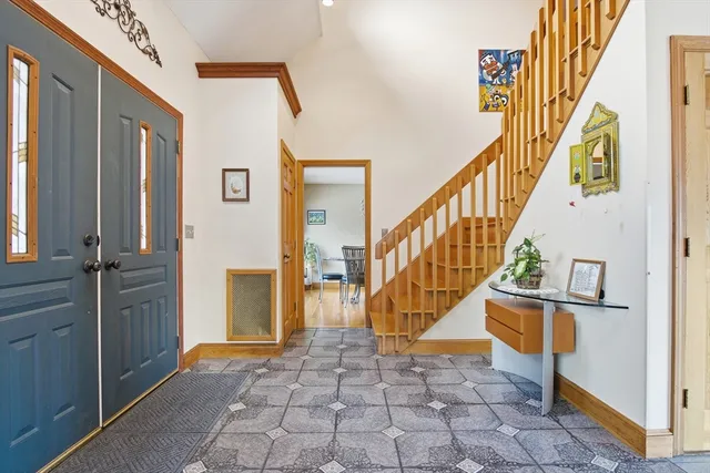 a view of entryway and hall with a front door