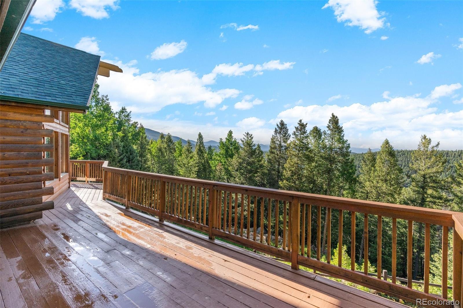 10248 Christopher Drive Conifer, CO 80433 - Photo 19 of 40 a view of balcony with wooden floor and fence