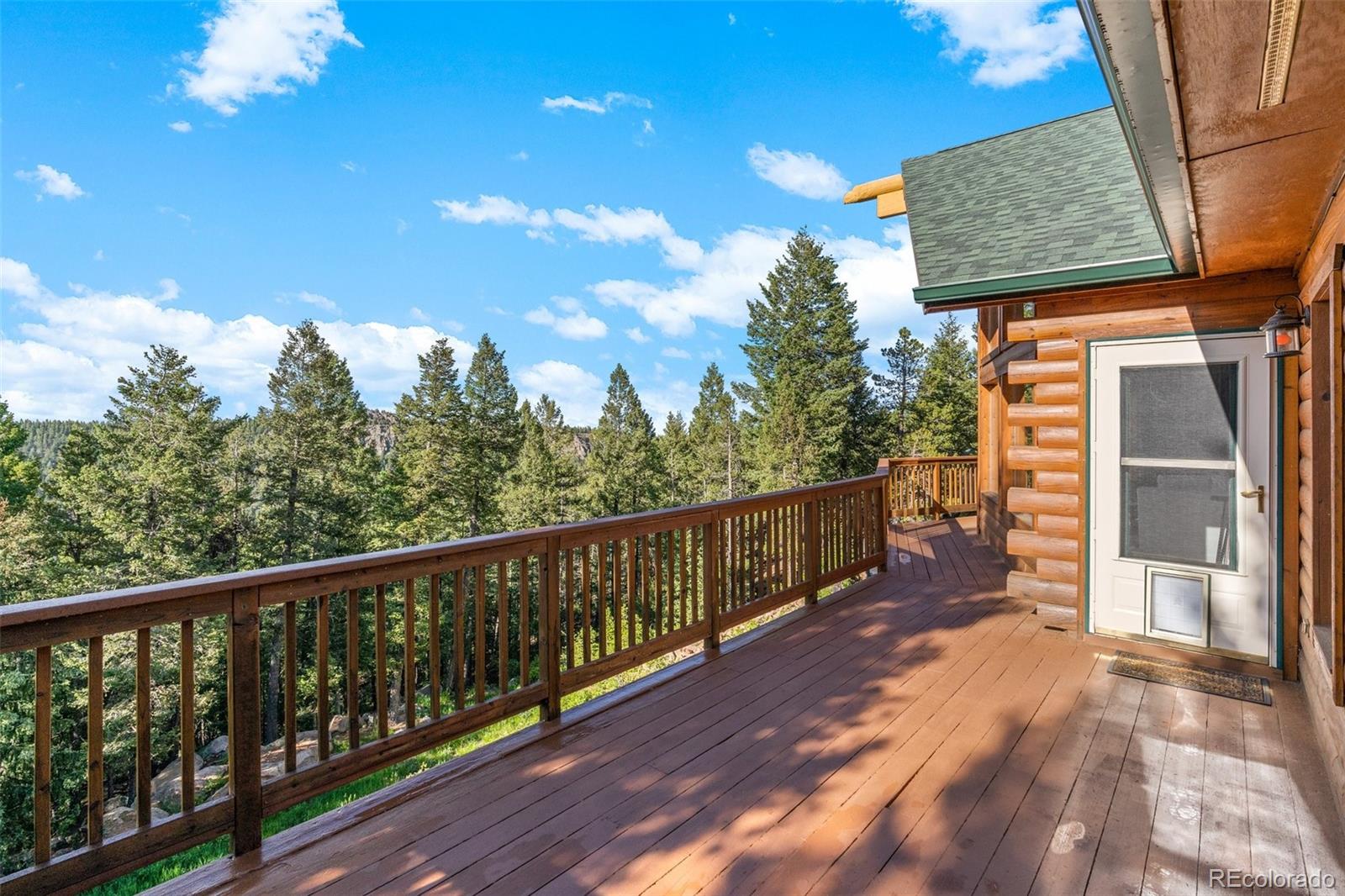 10248 Christopher Drive Conifer, CO 80433 - Photo 20 of 40 a view of a balcony with trees