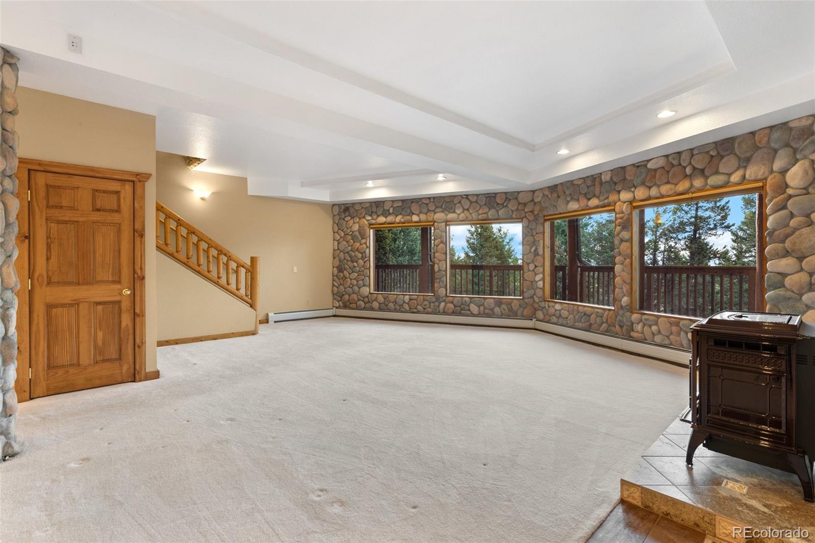 10248 Christopher Drive Conifer, CO 80433 - Photo 28 of 40 a view of an empty room with a fireplace and a window