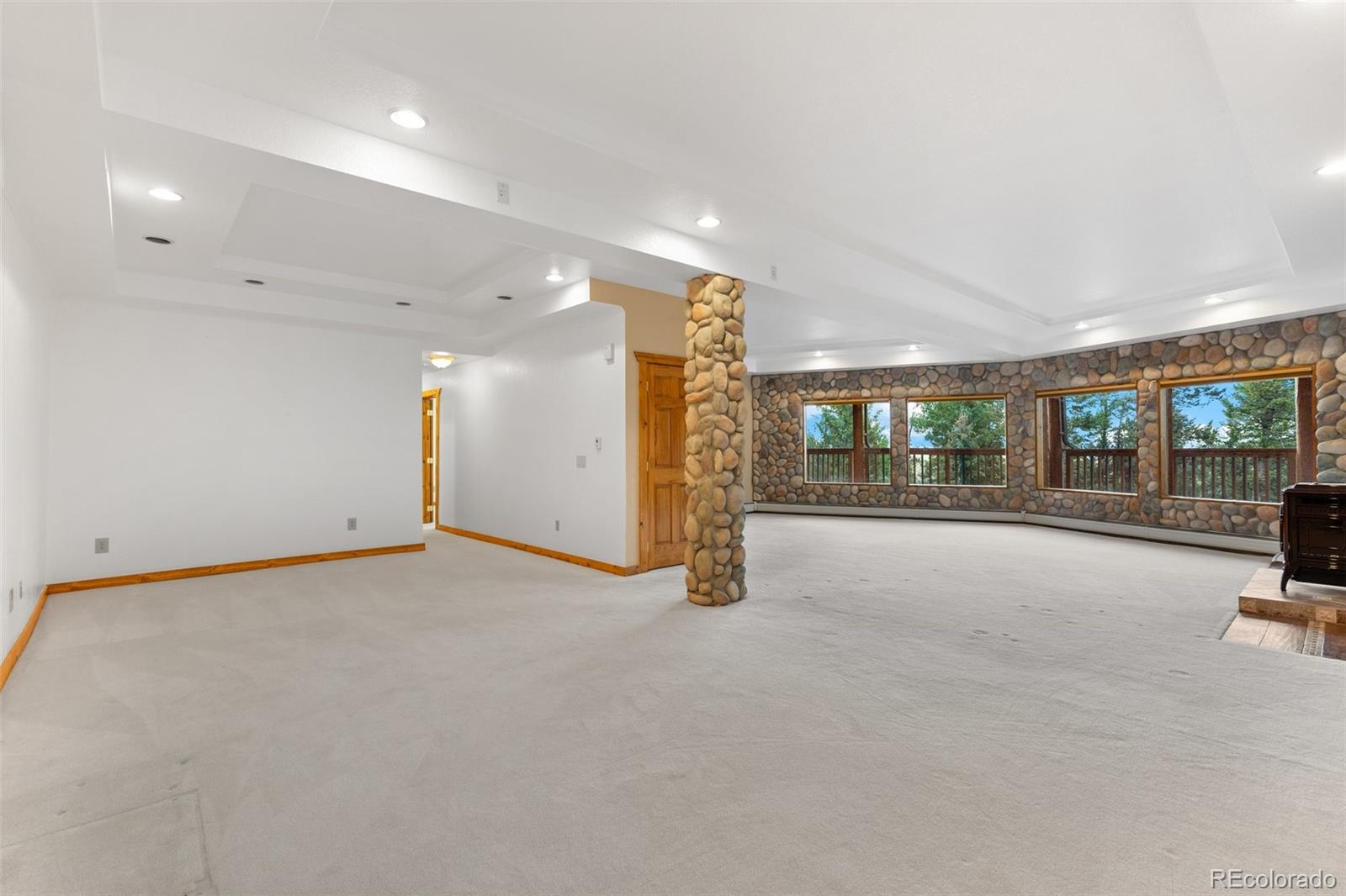 10248 Christopher Drive Conifer, CO 80433 - Photo 30 of 40 a view of an empty room with a sliding door
