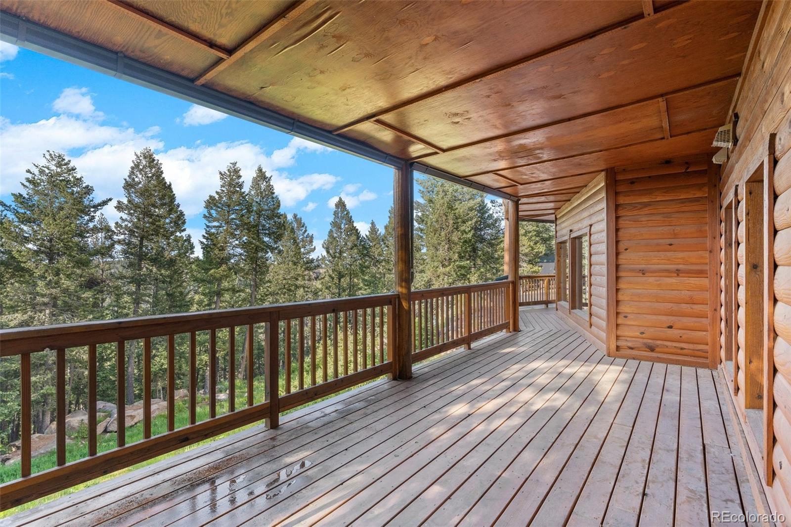 10248 Christopher Drive Conifer, CO 80433 - Photo 34 of 40 a view of a balcony with wooden floor