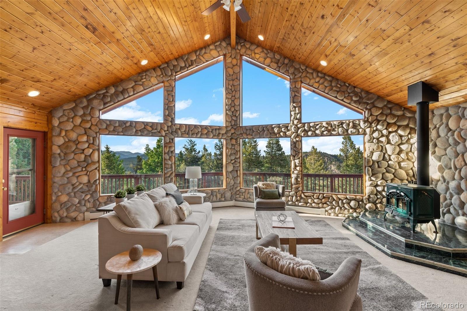 10248 Christopher Drive Conifer, CO 80433 - Photo 6 of 40 a balcony with furniture and a potted plant