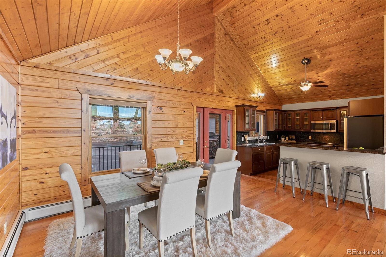 10248 Christopher Drive Conifer, CO 80433 - Photo 9 of 40 a view of a dining room with furniture and wooden floor