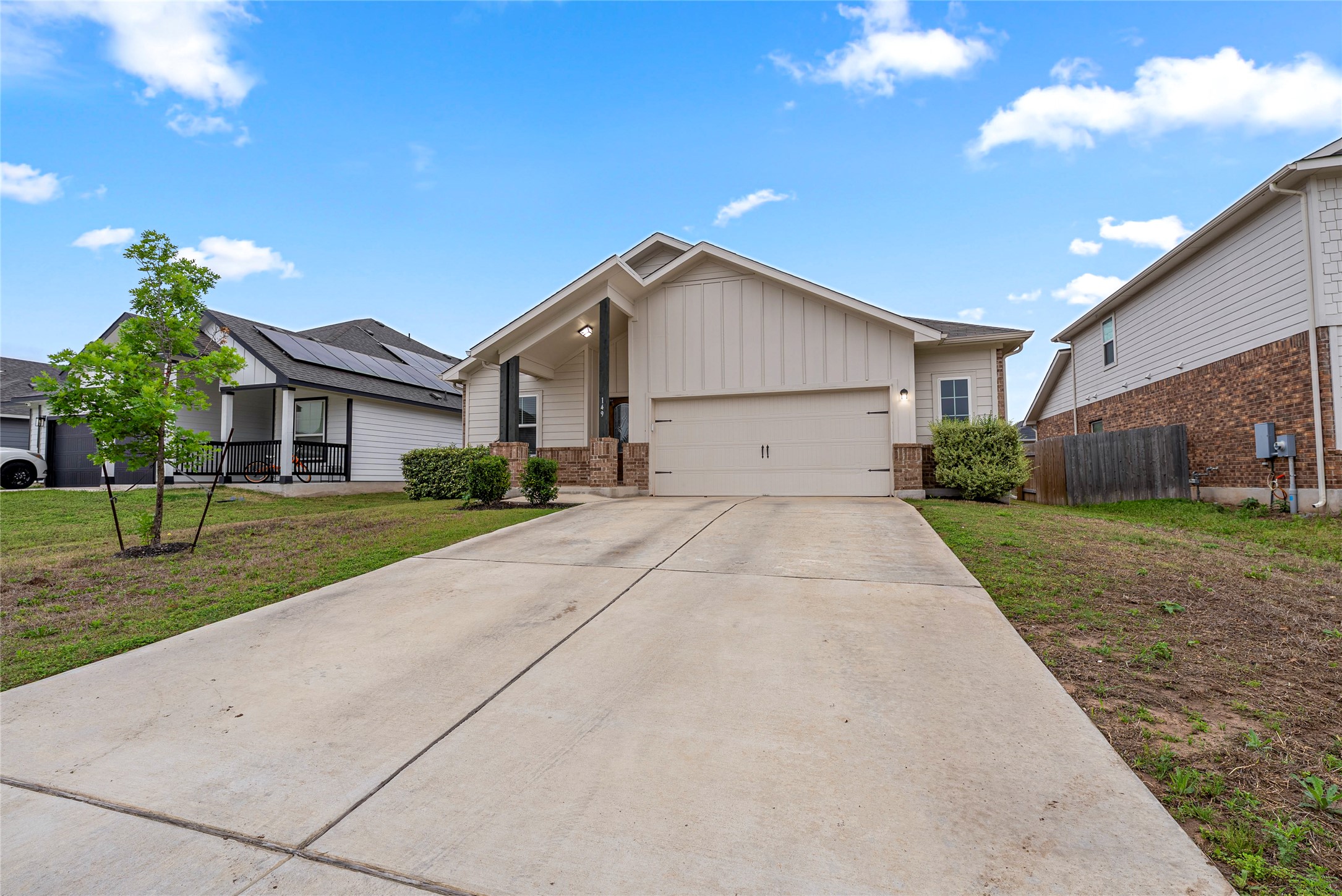 149 Biscayne Drive Kyle, TX 78640 - Photo 2 of 20 a view of garage yard and front view of a house