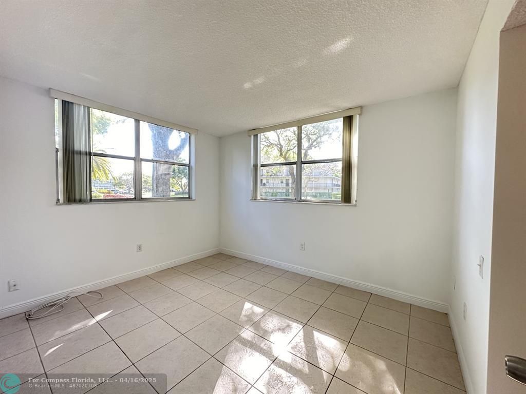 9401 Lime Bay Boulevard, Unit 115 Tamarac, FL 33321 - Photo 15 of 18 a view of an empty room with a window