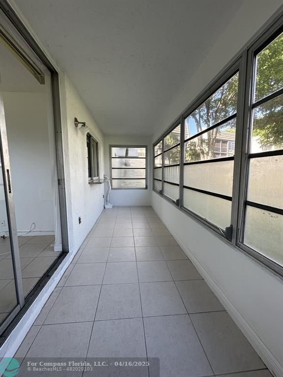 9401 Lime Bay Boulevard, Unit 115 Tamarac, FL 33321 - Photo 16 of 18 a view of an empty room with a window