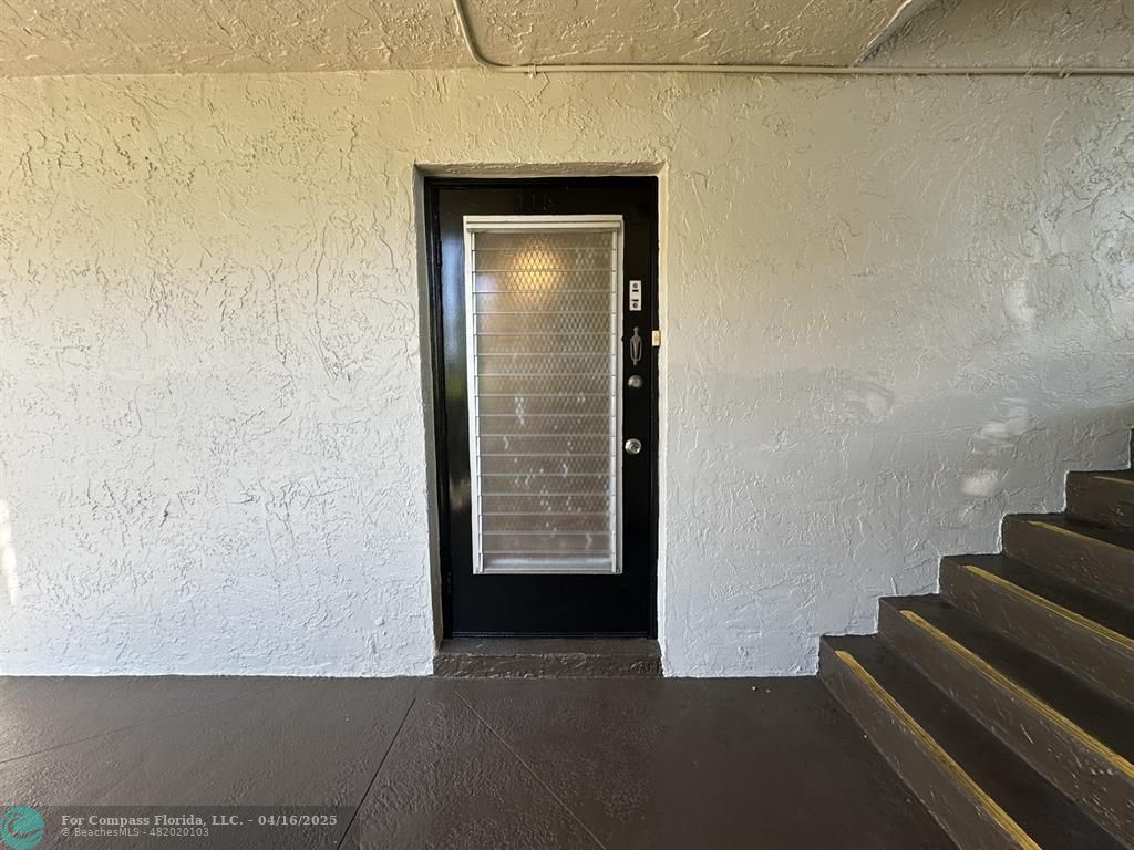 9401 Lime Bay Boulevard, Unit 115 Tamarac, FL 33321 - Photo 4 of 18 a view of an empty room with stairs