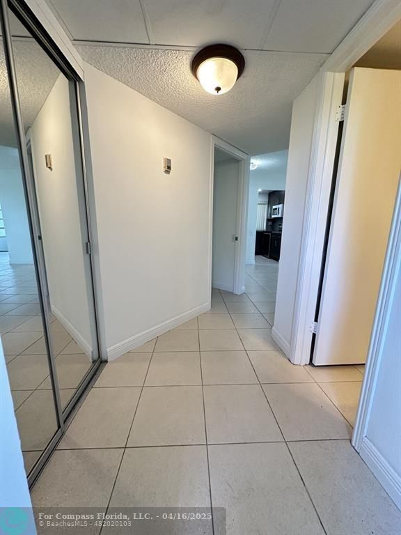 9401 Lime Bay Boulevard, Unit 115 Tamarac, FL 33321 - Photo 5 of 18 a view of a hallway to rooms