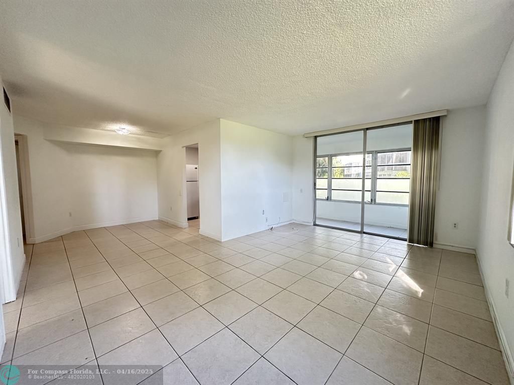 9401 Lime Bay Boulevard, Unit 115 Tamarac, FL 33321 - Photo 7 of 18 a view of an empty room and window