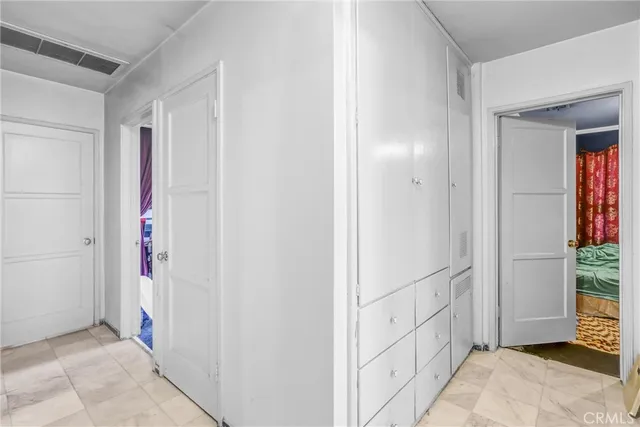 a bedroom with a bed a window and dresser