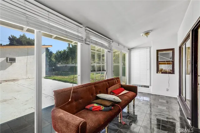 a kitchen that has a lot of cabinets in it and wooden floors