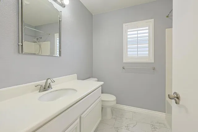a bathroom with a sink toilet and vanity