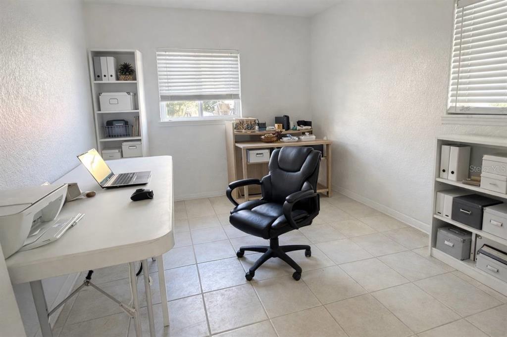 445 State Rte 415 Osteen, FL 32764 - Photo 17 of 25 a view of a workspace with furniture and a window
