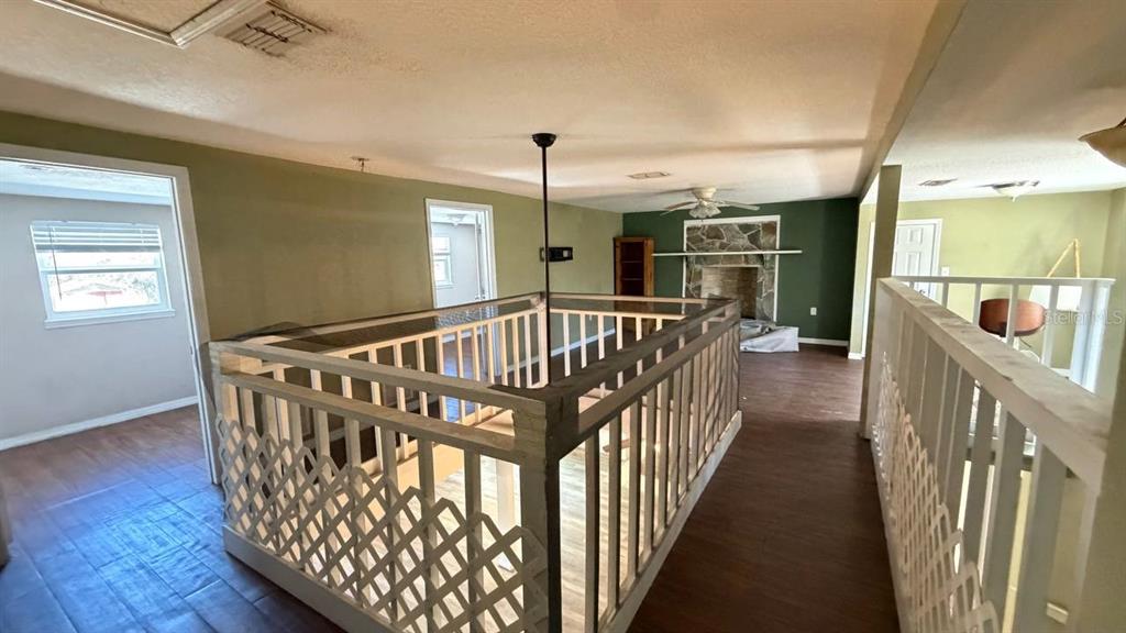 445 State Rte 415 Osteen, FL 32764 - Photo 20 of 25 a view of staircase with lots of wooden floor and windows