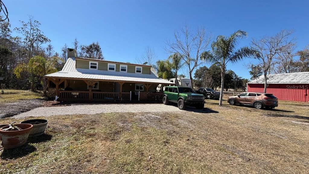 445 State Rte 415 Osteen, FL 32764 - Photo 3 of 25 a view of a house with a patio