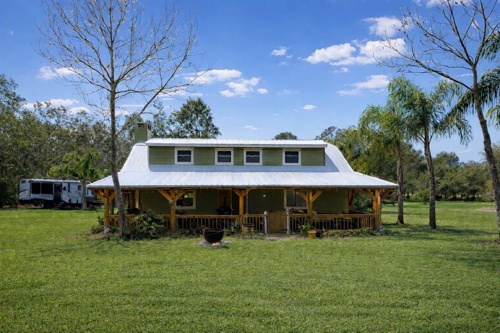 445 State Rte 415 Osteen, FL 32764 - Photo 3 of 14 a front view of a house with garden