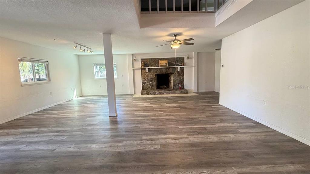 445 State Rte 415 Osteen, FL 32764 - Photo 7 of 25 a view of an empty room with a fireplace and chandelier fan