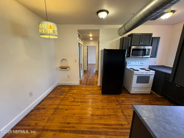 a kitchen with stainless steel appliances granite countertop a refrigerator a stove top oven a sink and dishwasher