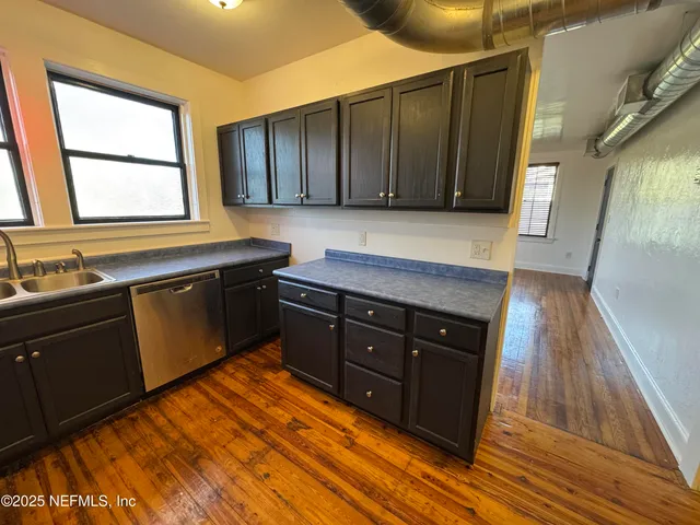 a kitchen with wooden cabinets and a sink