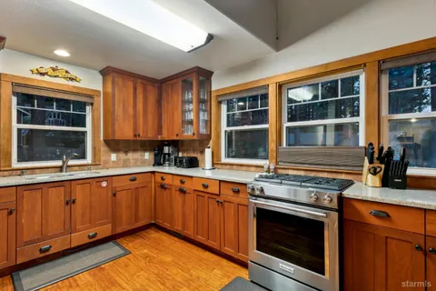 a kitchen with stainless steel appliances granite countertop a stove and a sink