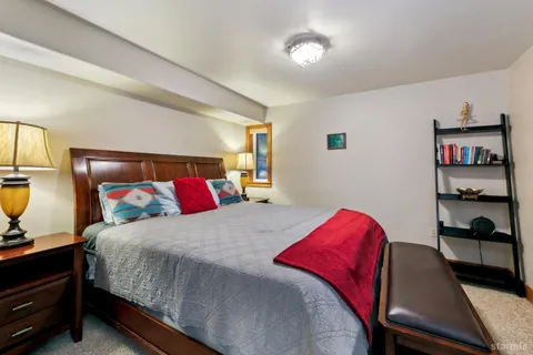 a bedroom with a bed and dresser