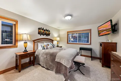 a bedroom with a bed and a flat screen tv