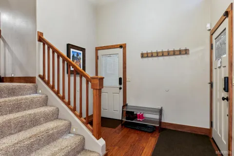 a view of an entryway with wooden floor
