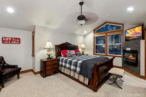 a bedroom with a bed and a tv