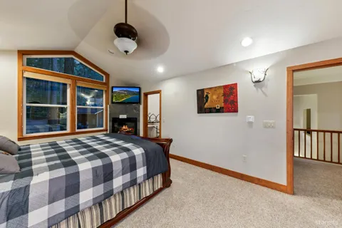 a bedroom with a large bed and a window