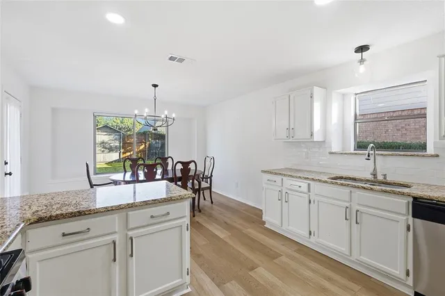 a kitchen with counter top space and sink