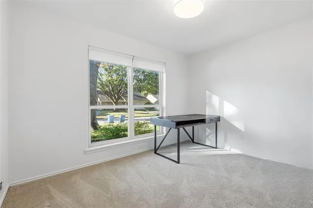 a view of workspace with furniture and window