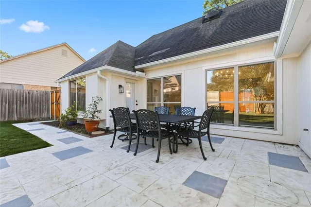 a view of a patio with table and chairs