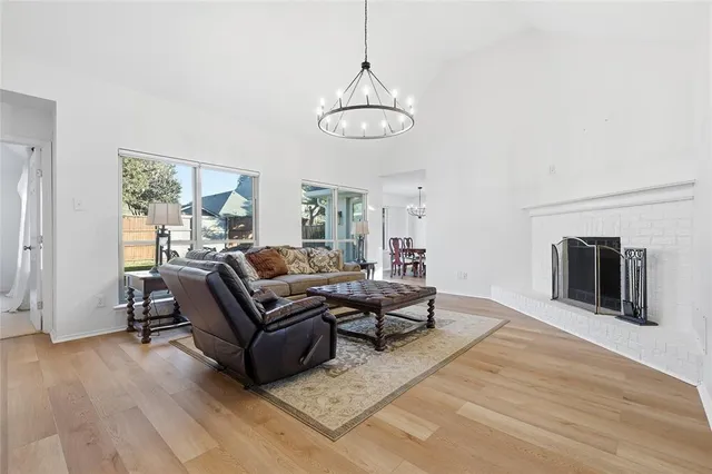 a living room with furniture wooden floor and a fireplace