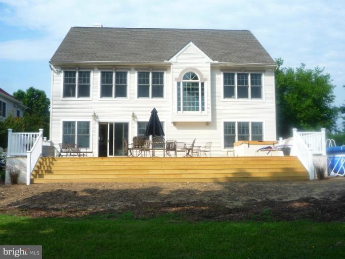 8563 Bay Road Pasadena, MD 21122 - Photo 24 of 25 Deck has steps to the lawn leads to the water.