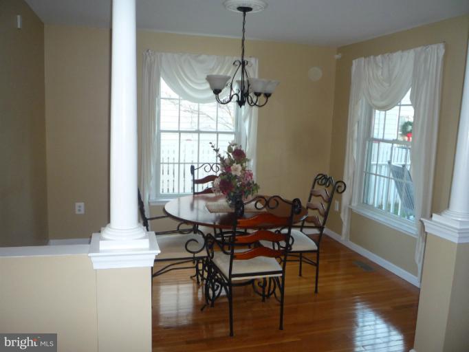 8563 Bay Road Pasadena, MD 21122 - Photo 6 of 25 Dining area with wood floor.