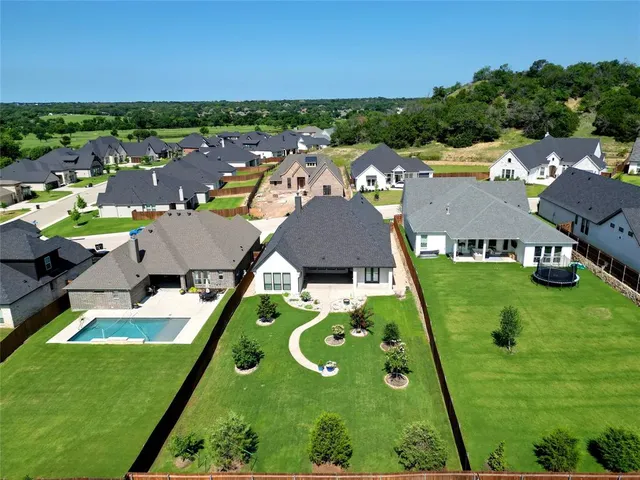 an aerial view of a house with yard swimming pool and outdoor seating