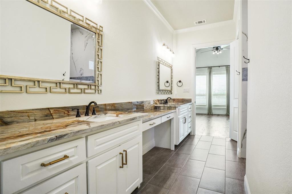 1208 Vly Rdg Drive Weatherford, TX 76087 - Photo 21 of 32 a large bathroom with a granite countertop double vanity sink a mirror and a bathtub