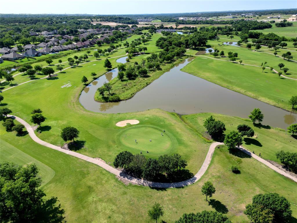 1208 Vly Rdg Drive Weatherford, TX 76087 - Photo 4 of 32 an aerial view of a golf course with a garden