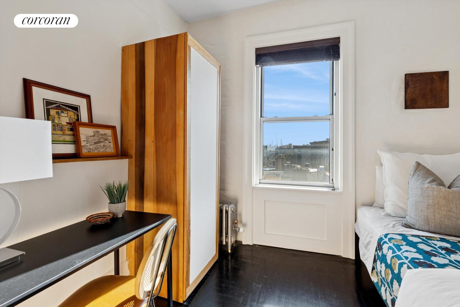 930 St Nicholas Avenue, Unit 53 Manhattan, NY 10032 - Photo 5 of 12 a bedroom with a bed and a window