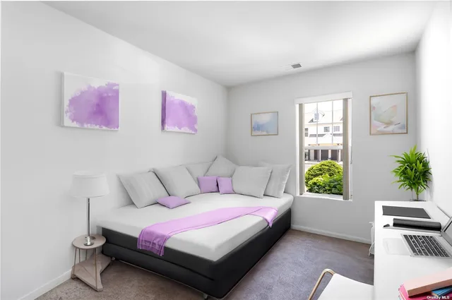 a spacious bedroom with a bed and a window