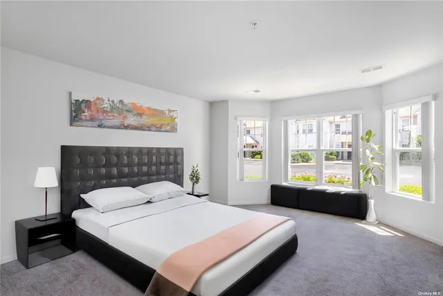 a bedroom with a large bed and a window