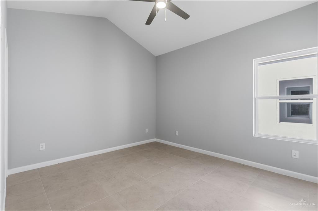 2612 Mockingbird Road, Unit 3 Weslaco, TX 78596 - Photo 8 of 11 an empty room with a window and ceiling fan
