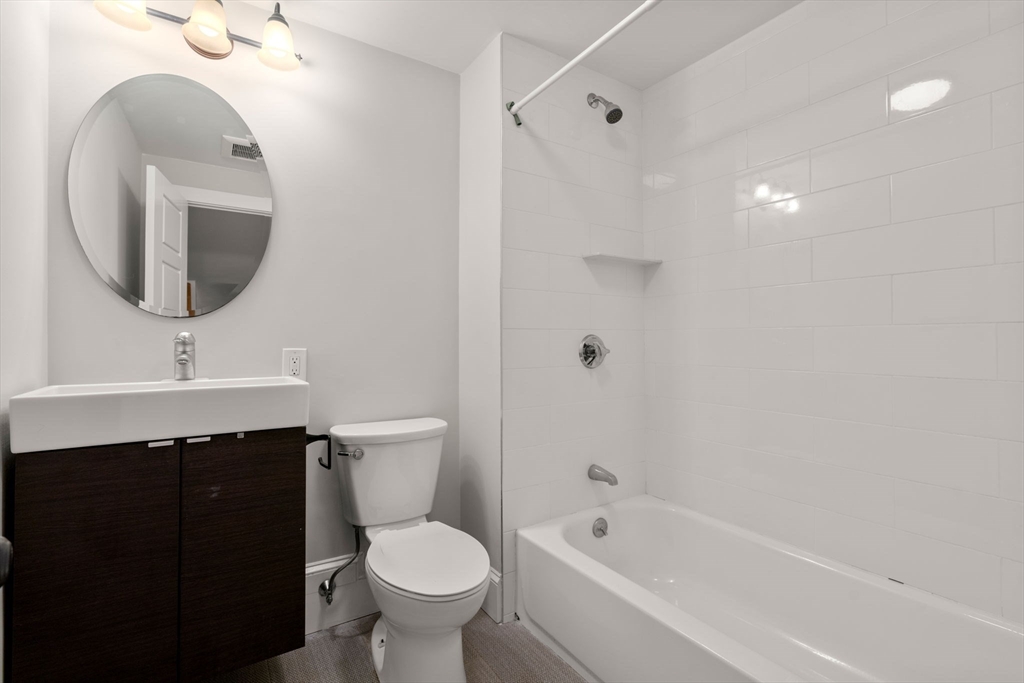 129 Sutherland Road, Unit A Boston, MA 02135 - Photo 17 of 38 a bathroom with a sink toilet and shower